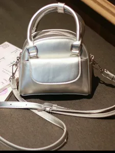 Silver metallic dome handbag for women, retro top handle crossbody bag with front pocket.