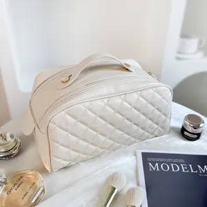 White quilted travel cosmetic bag detail, featuring soft PU leather and secure double zippers.