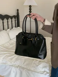 Close-up detail view of the retro black tote shoulder bag featuring chic metallic hardware.