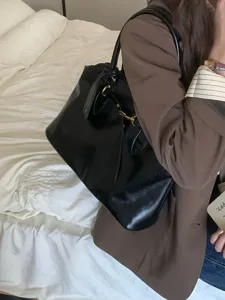 Vintage black commuter tote bag for women, stylish large capacity shoulder handbag details.