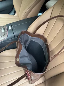 Detailed view of the large capacity soft leather brown tote bag interior design.