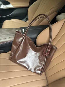 Dark brown glossy soft leather tote bag with heart charm, stylish fashion shoulder handbag.