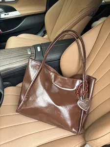 Brown soft leather tote bag with heart charm, stylish large capacity dark shoulder handbag.