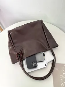 Detail view of the dark brown glossy soft leather tote bag showing large capacity and inside.