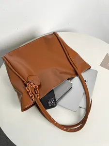 Brown soft leather tote bag large capacity shoulder handbag with chic heart charm and chain detail.