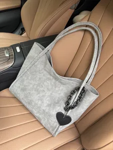 Grey soft leather tote bag with stylish heart chain charm, large capacity shoulder handbag.