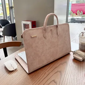 Stylish pink PU leather laptop sleeve bag with top handle and secure metal lock closure.