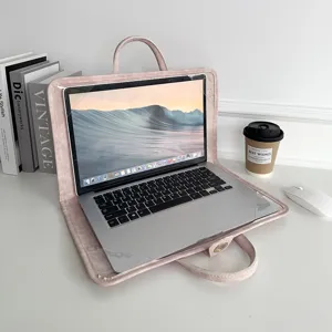 Close-up detail of the pink suede laptop sleeve showcasing its soft texture and handle design.