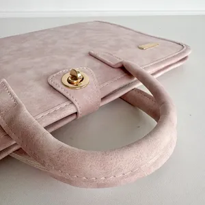 Pink PU leather laptop sleeve detail shot, business casual notebook carrying case with handle.