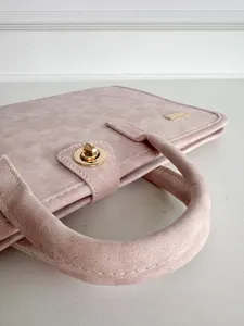 Pink minimalist laptop sleeve with handles, stylish business computer bag for women and men.