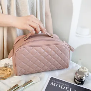 Detailed view of the stylish quilted travel cosmetic bag with convenient handle and zipper.
