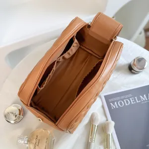 Large capacity quilted travel makeup bag, portable leather cosmetic storage organizer.