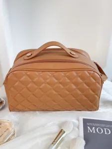 Brown quilted cosmetic bag with handle and zipper, large capacity travel toiletry storage case.
