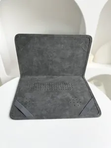 Detailansicht der dunkelgrauen Leder-Laptoptasche mit Gummibändern und Lüftungsschlitzen.
