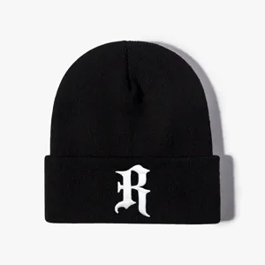 Black knit beanie with white gothic letter embroidery, stylish streetwear for outdoor wear.