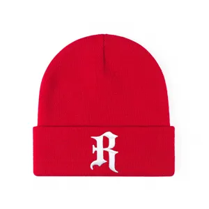 Close-up red knit beanie hat featuring detailed white gothic letter R embroidery design.