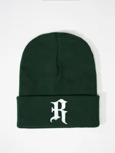 Dark green knit beanie with white gothic R embroidery, cozy winter hat for outdoor wear.