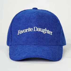 Blue corduroy baseball hat featuring white embroidered text detail, stylish casual outdoor cap.