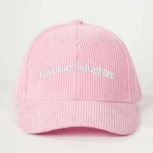 Pink corduroy baseball cap front detail showing white text embroidery design style nicely.