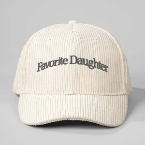 Close-up shot of the embroidered corduroy baseball cap showcasing neat text details and texture.