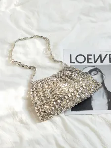 Silver metallic beaded shoulder bag detail, elegant woven design for women evening.