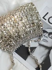 Detailed shot of a silver beaded woven shoulder bag showcasing intricate craftsmanship.