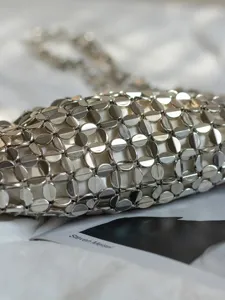 Silver metallic sequin woven handbag detail shot, showcasing exquisite craftsmanship and chain.