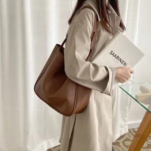 Elegant brown leather tote shoulder bag for women, spacious minimalist daily casual handbag.