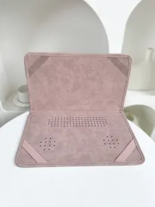 Pink PU leather laptop sleeve detail showing ventilation holes and elastic corner bands.