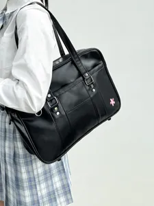 Detailed view of black Japanese JK uniform bag with pink cherry blossom embroidery, large capacity.
