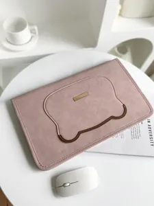 Cute minimalist pink laptop sleeve detail view with bear shape pocket and gold metal tag accent