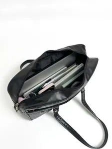 Detail view of black PU leather JK uniform shoulder bag showcasing large capacity interior space.