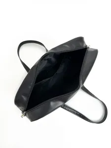 Black PU leather shoulder bag interior detail showing large capacity and zipper pocket structure.