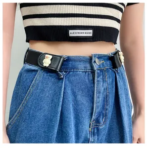 Detailed view of a black stretch lazy waist belt featuring a cute bear decor worn on denim jeans.