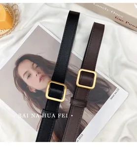 Women narrow black brown holeless belt with vintage gold square buckle for summer fashion look.