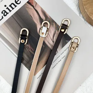 Women's minimalist thin leather belt with gold tone metal oval buckle for dress and shirt.