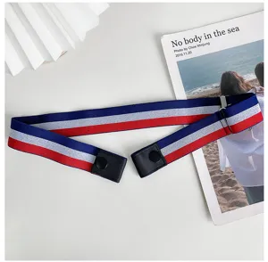 Detail view of a tricolor elastic waist belt with snap ends and metal adjuster buckle.