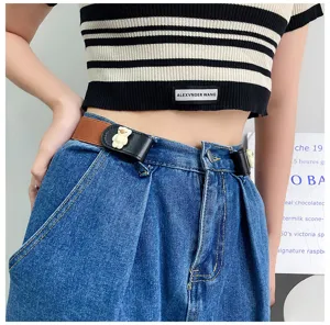 Close-up detail of the elastic lazy belt with cute bear buckle worn on jeans, perfect.