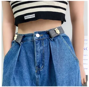Detail shot of the invisible elastic lazy waist belt with cute bear design on denim jeans.