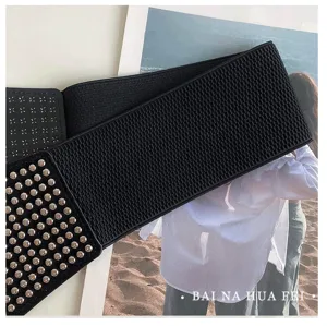 Women's wide elastic waist belt with metal studs, punk style fashion accessory for suit.