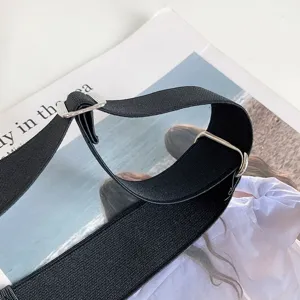 Adjustable black elastic waist belt with metal buckle, invisible stretch design for jeans.
