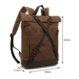 Vintage canvas backpack detail showing retro brown color, roll-top design and dimensions.