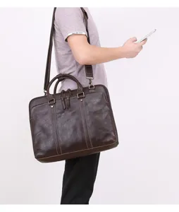 Detailed close-up view of brown leather men business briefcase messenger bag with shoulder strap.