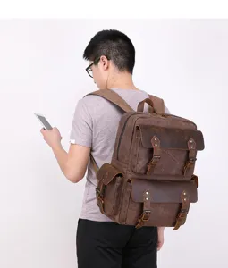 Detailed view of vintage canvas leather backpack with multiple pockets and durable straps.
