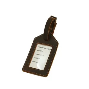 Detailed view of vintage genuine leather luggage tag with transparent window and sturdy strap.