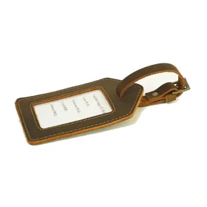 Vintage genuine leather luggage tag with buckle strap and clear ID window for travel.