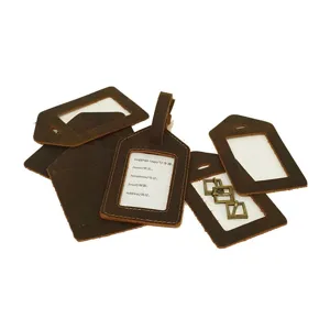 Vintage genuine leather luggage tags set detail, brown cowhide travel bag ID name card holders.