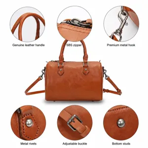Vintage brown leather Boston handbag with top handles, crossbody strap and hardware.