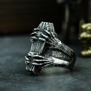 Close up detail view of the retro gothic coffin skeleton claw silver ring texture and craftsmanship.