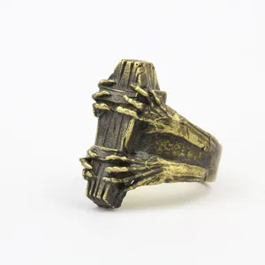 Gothic vintage coffin ring detail showcasing intricate skeleton hands and antique brass finish.